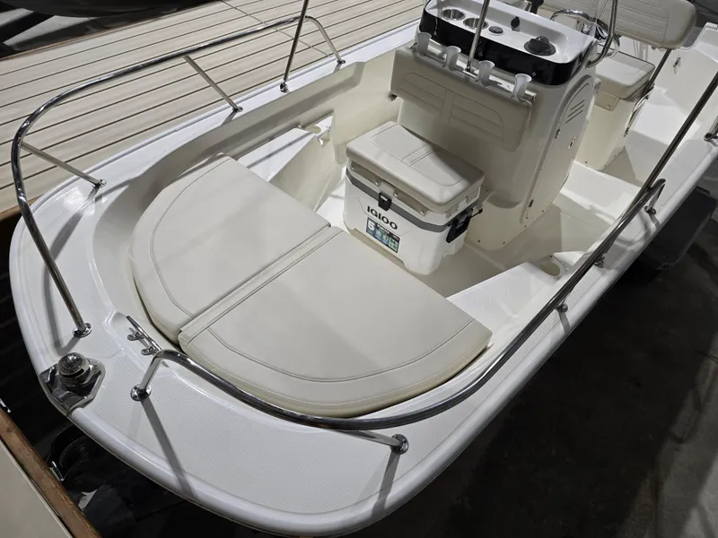 Slide: The Image of 2025 Boston Whaler 150 Montauk boat in a warehouse, on a trailer. - 6