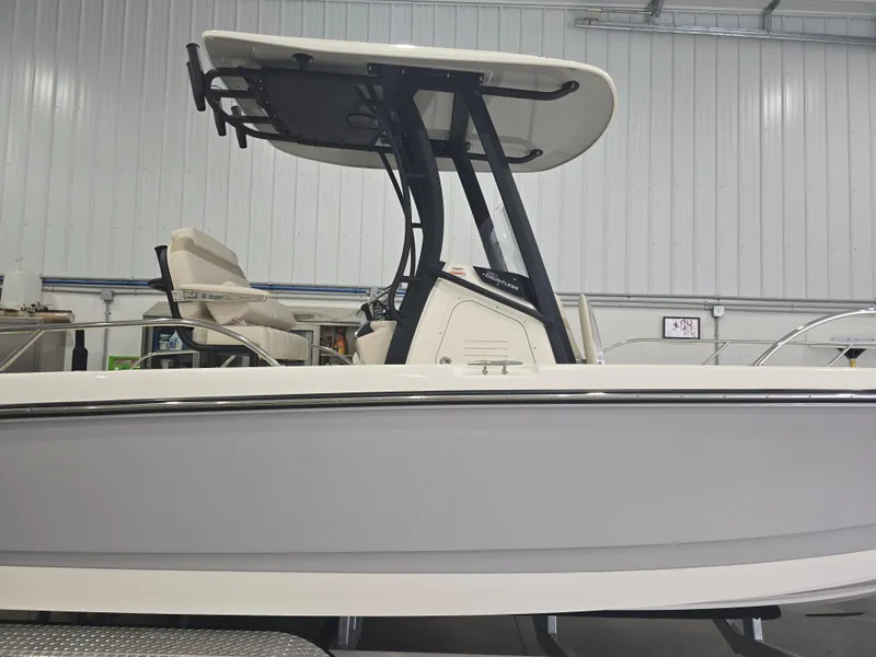 Slide: The Image of 2025 Boston Whaler 250 Dauntless boat interior in a garage setting. - 11