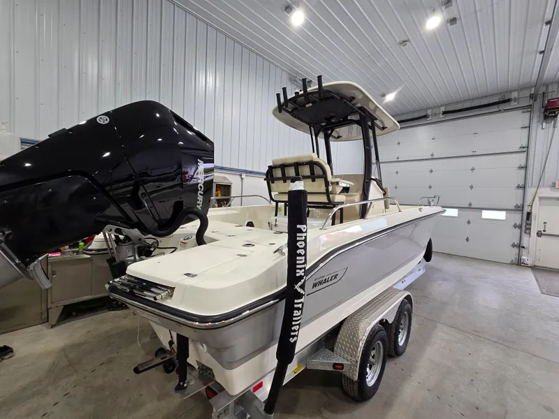 Slide: The Image of 2025 Boston Whaler 250 Dauntless boat interior with cushioned seating and stainless steel railings. - 13