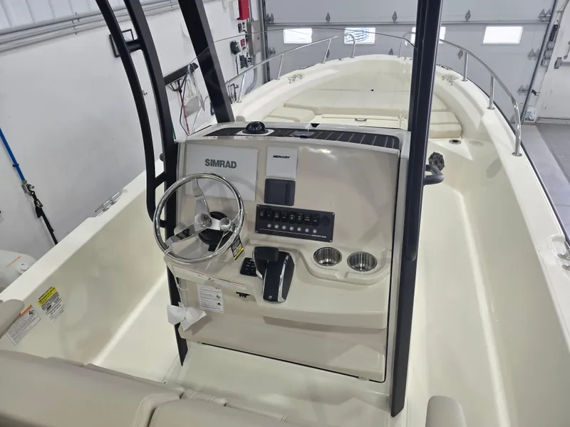 Slide: The Image of 2025 Boston Whaler 250 Dauntless boat seating with cushioned backrest and armrests. - 19