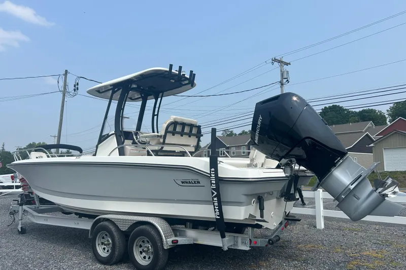 Slide: The Image of 2025 Boston Whaler 250 Dauntless boat on trailer in indoor storage. - 2