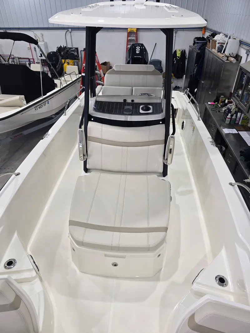 Slide: The Image of 2025 Boston Whaler 250 Dauntless boat interior with seating and console view. - 23