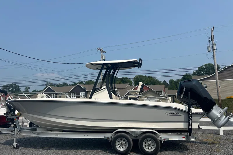 Slide: The Image of 2025 Boston Whaler 250 Dauntless boat in indoor storage on a trailer. - 3