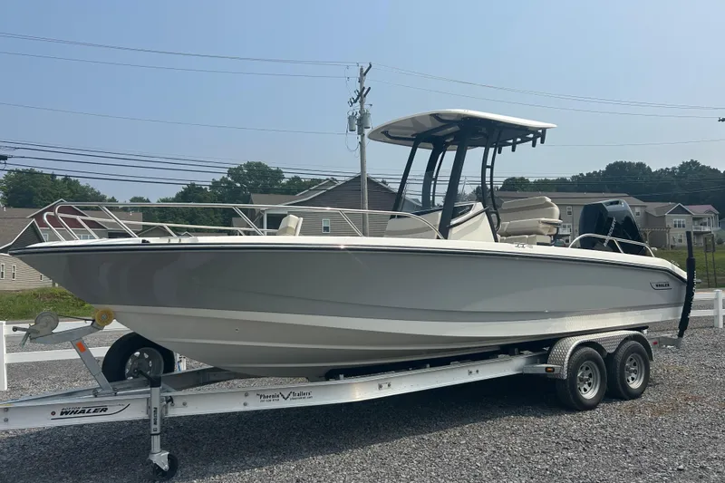 Slide: The Image of 2025 Boston Whaler 250 Dauntless boat in a garage, featuring a powerful outboard motor. - 4