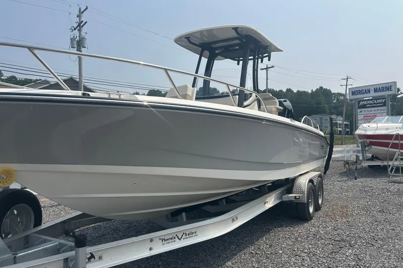 Slide: The Image of 2025 Boston Whaler 250 Dauntless boat in a garage, showcasing powerful outboard motor. - 5