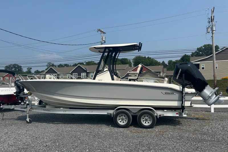Slide: The Image of 2025 Boston Whaler 250 Dauntless boat in a garage, featuring a powerful outboard motor. - 7