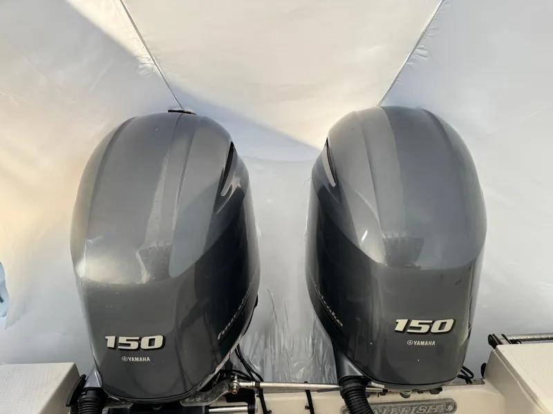 Slide: The Image of Twin Yamaha 150 outboard engines on a 2022 Sailfish 242 CC boat. - 11
