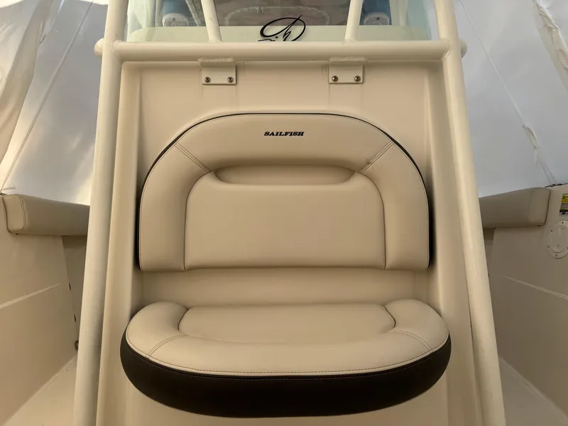Slide: The Image of 2022 Sailfish 242 CC boat seat with beige and black upholstery. - 2