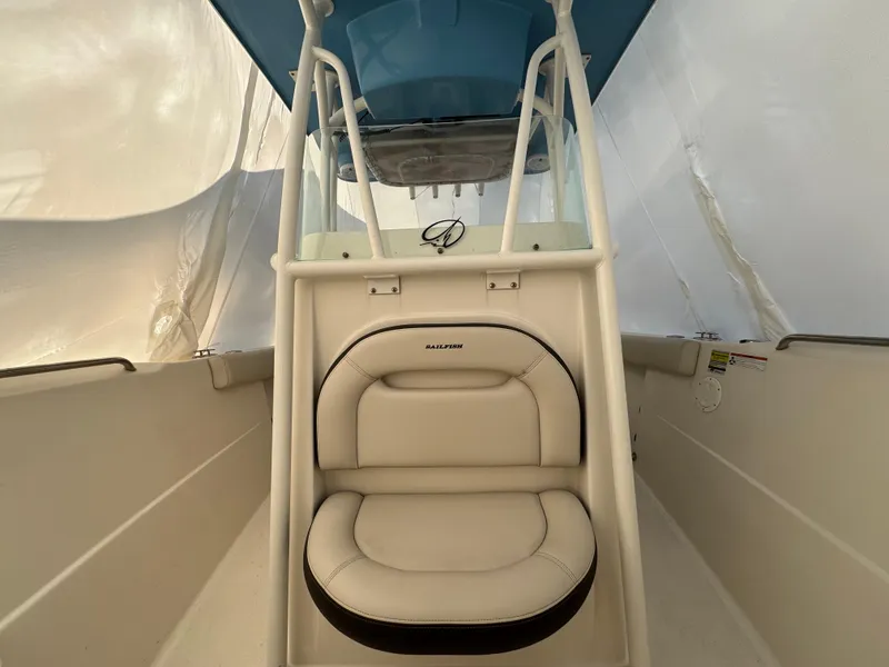 Slide: The Image of 2022 Sailfish 242 CC boat interior with cushioned seating and console. - 3