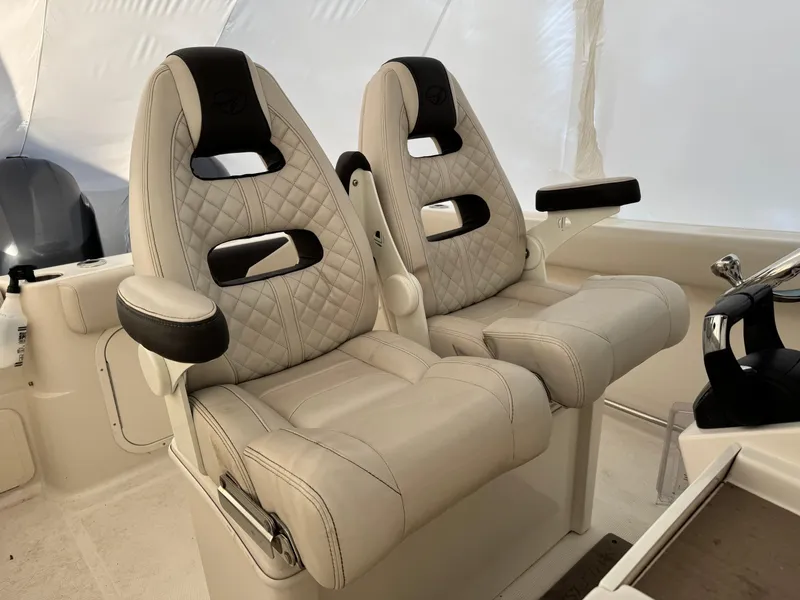 Slide: The Image of Luxurious seating in 2022 Sailfish 242 CC boat with quilted upholstery and armrests. - 8