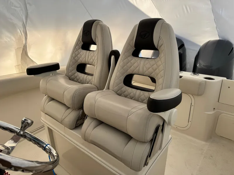 Slide: The Image of Luxurious seating on 2022 Sailfish 242 CC boat with dual cushioned chairs. - 9