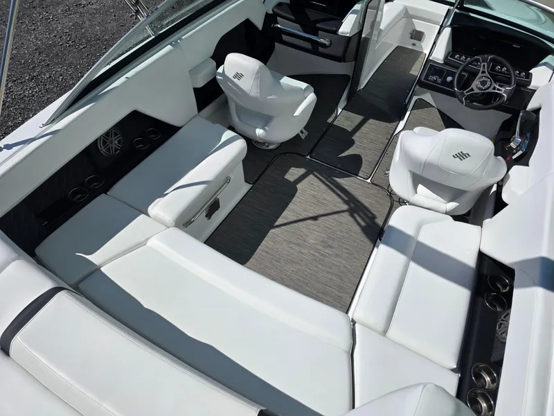 Slide: The Image of 2025 Four Winns H4 boat interior with white seating and modern dashboard design. - 12