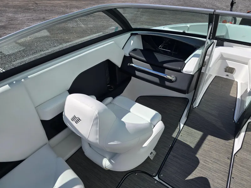 Slide: The Image of 2025 Four Winns H4 boat interior with sleek white seating and modern dashboard design. - 13