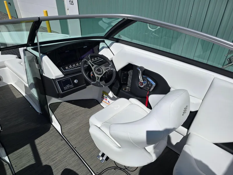 Slide: The Image of 2025 Four Winns H4 boat interior with modern steering and white seating. - 14