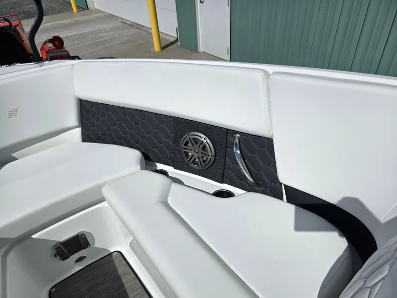 Slide: The Image of 2025 Four Winns H4 boat interior with white seating and speaker detail. - 17