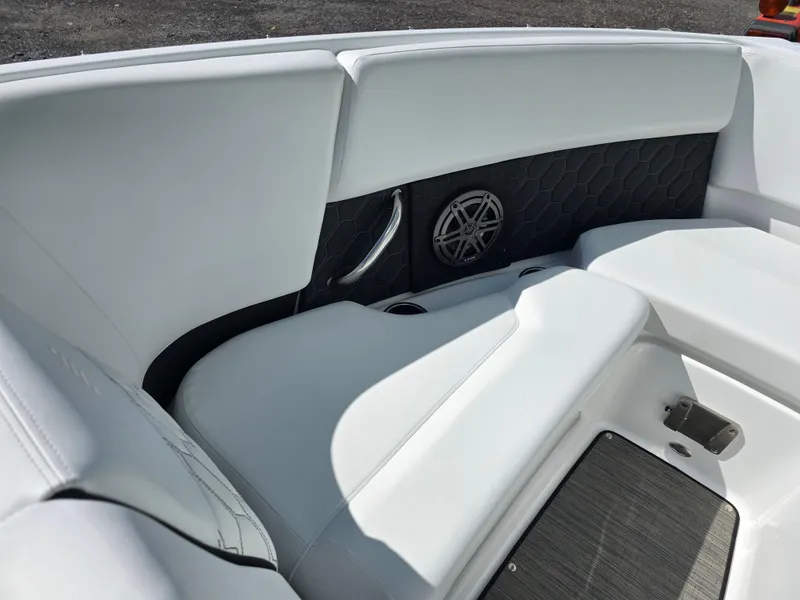 Slide: The Image of 2025 Four Winns H4 boat interior with white seating and speaker detail. - 18