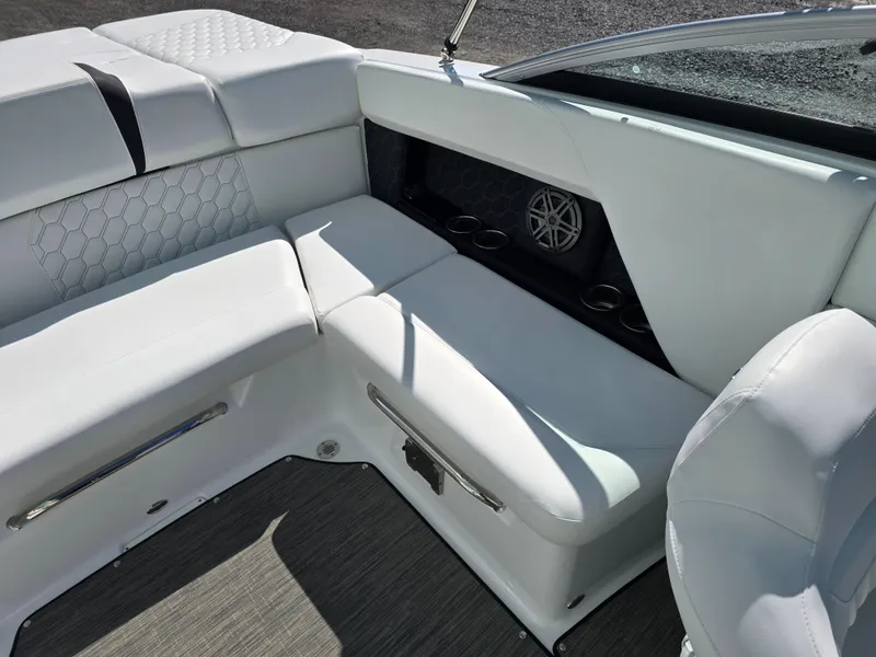 Slide: The Image of 2025 Four Winns H4 boat interior with white seating and speaker system. - 20