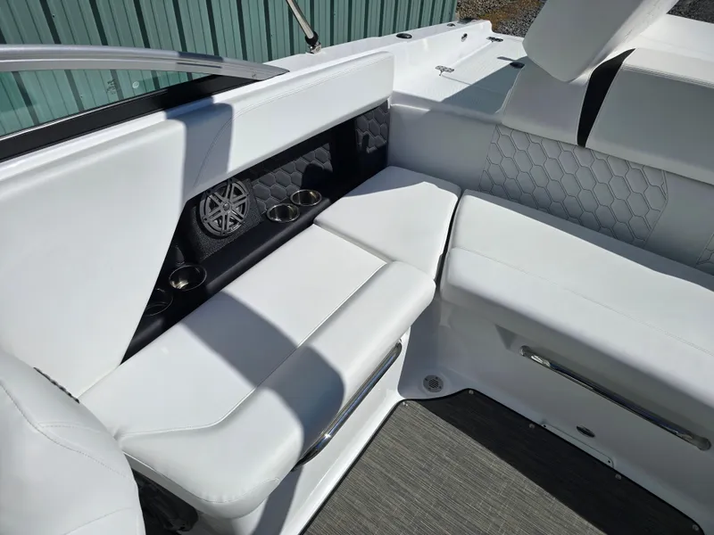 Slide: The Image of 2025 Four Winns H4 boat interior with white seating and built-in speakers. - 21