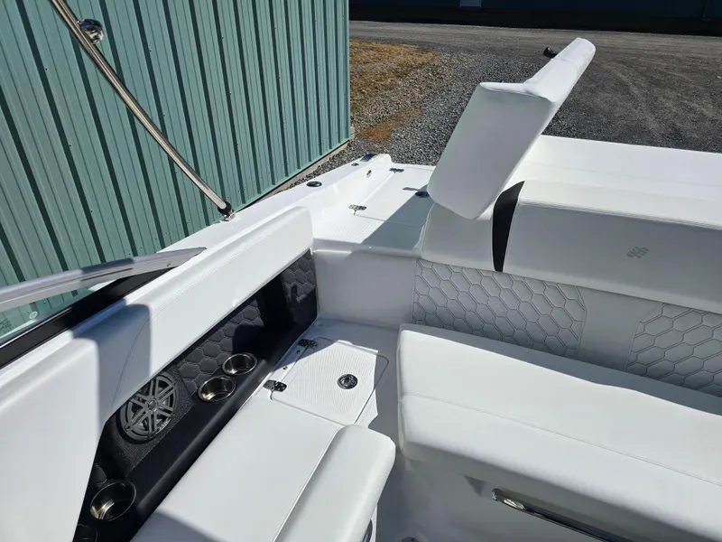 Slide: The Image of 2025 Four Winns H4 boat interior with white seating and speaker system. - 22