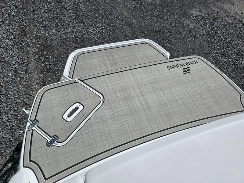 Slide: The Image of 2025 Four Winns H4 boat deck with textured surface and logo. - 29