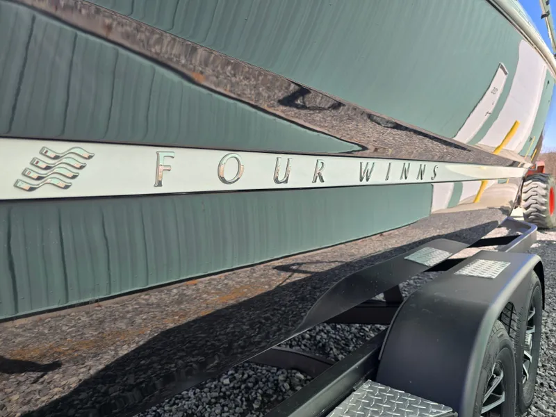 Slide: The Image of 2025 Four Winns H4 boat side view with logo and trailer. - 8