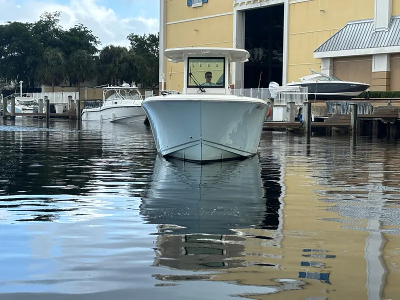 Slide: The Image of 2023 Sailfish 272 CC boat docked at marina, front view. - 2
