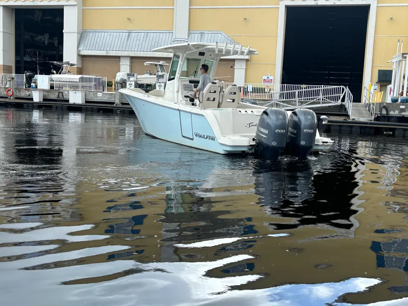 Slide: The Image of 2023 Sailfish 272 CC boat with dual engines docked in marina. - 5