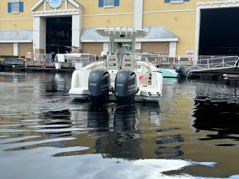 Slide: The Image of 2023 Sailfish 272 CC boat with dual Yamaha engines docked at marina. - 6