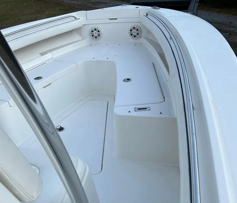 Slide: The Image of 2016 Regulator 23 Forward Seating boat interior with white seating and speakers. - 10