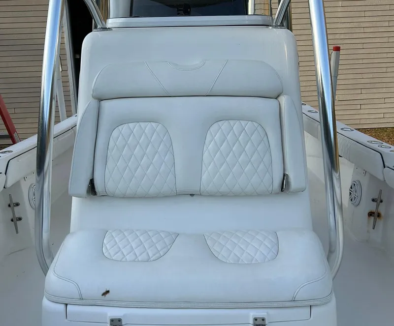 Slide: The Image of 2016 Regulator 23 Forward Seating boat with white cushioned seats. - 11
