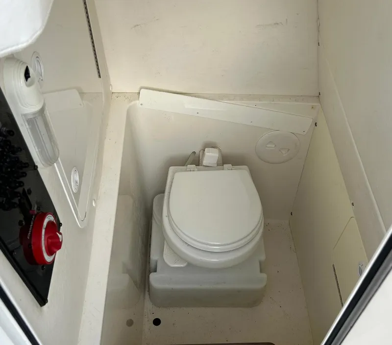 Slide: The Image of 2016 Regulator 23 Forward Seating boat interior with compact marine toilet. - 12