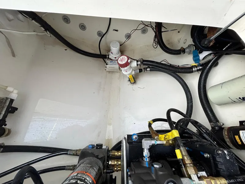 Slide: The Image of 2016 Regulator 23 Forward Seating boat engine compartment with hoses and fittings. - 13