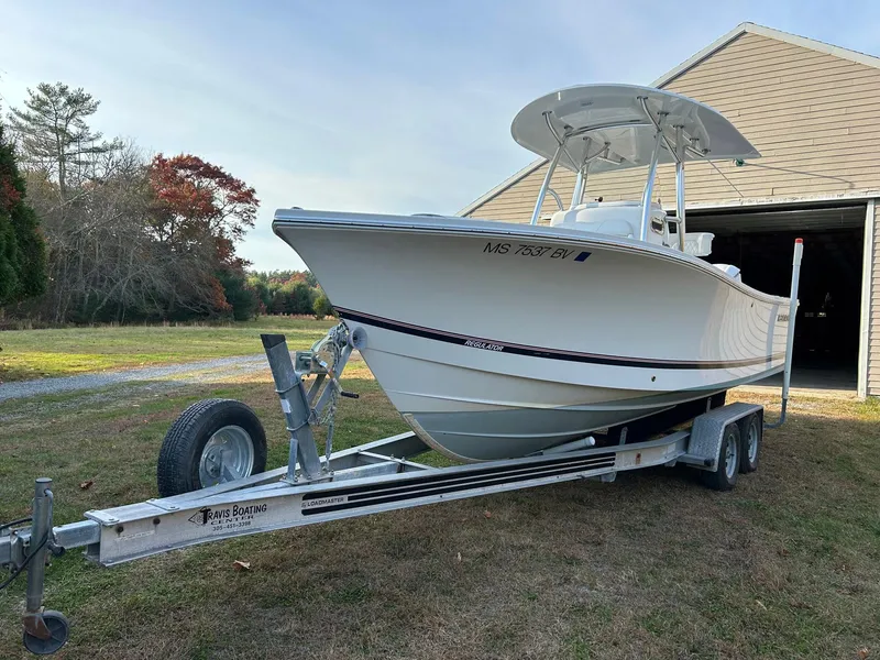 Slide: The Image of 2016 Regulator 23 Forward Seating boat on trailer near garage. - 14