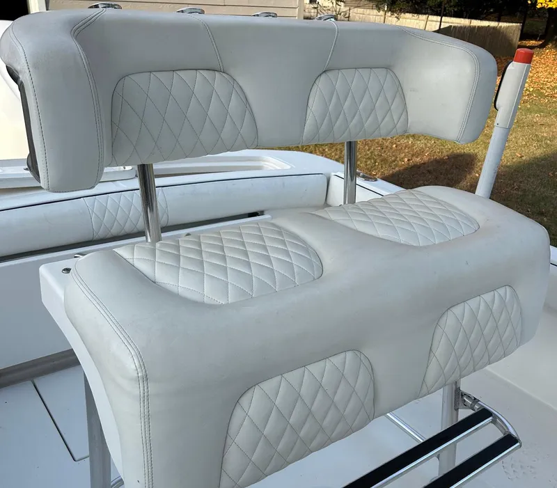 Slide: The Image of 2016 Regulator 23 Forward Seating boat with white cushioned seats. - 6