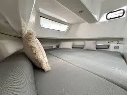 Slide: The Image of Interior cabin of 2025 Zodiac X10CC boat with cozy bedding and pillows. - 13
