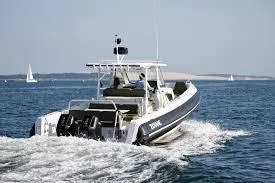 Slide: The Image of 2025 Zodiac X10CC boat cruising on open water with clear skies. - 3
