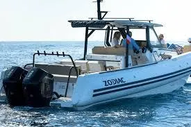 Slide: The Image of 2025 Zodiac X10CC boat cruising on open water with passengers onboard. - 7