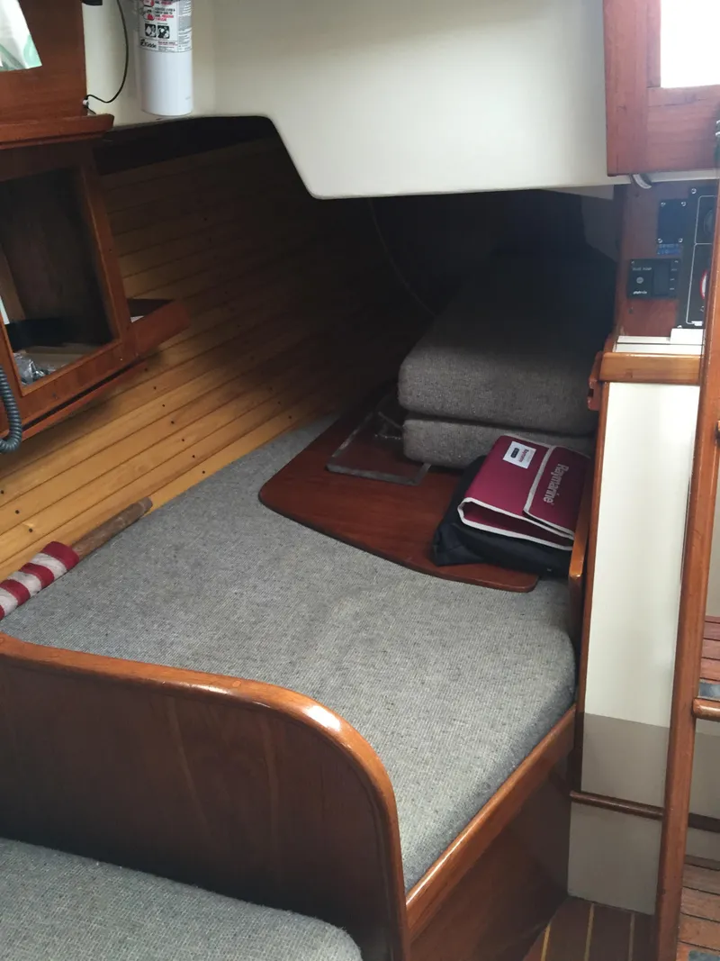 Slide: The Image of Interior cabin of 1988 Cape Dory 30 MK II sailboat with wooden accents and cushions. - 23