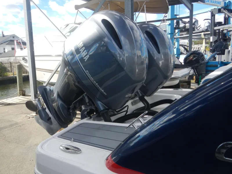 Slide: The Image of 2022 Chaparral 280 OSX with dual Yamaha outboard motors at a marina. - 3