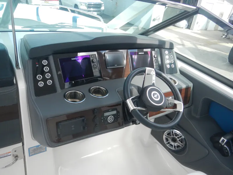 Slide: The Image of 2022 Chaparral 280 OSX boat dashboard with modern controls and steering wheel. - 8