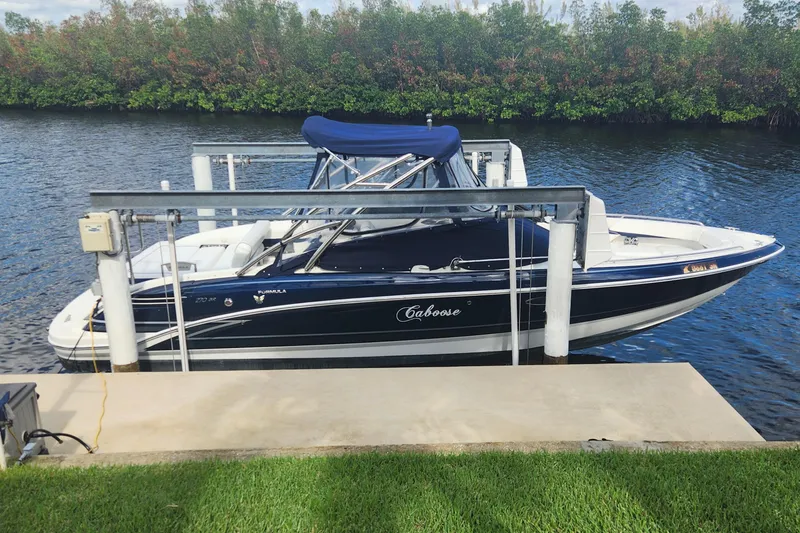 Slide: The Image of 2018 Formula 270 BR boat docked on a serene river with lush greenery. - 0
