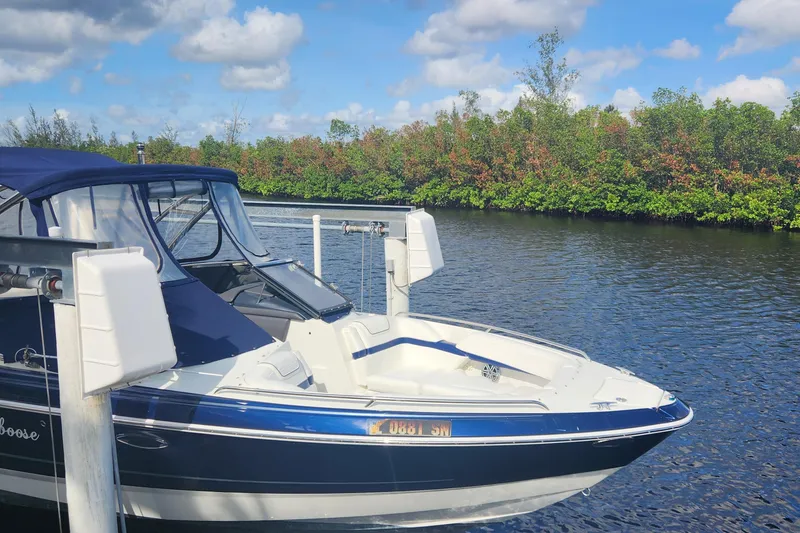 Slide: The Image of 2018 Formula 270 BR boat docked on a serene river with lush greenery. - 1