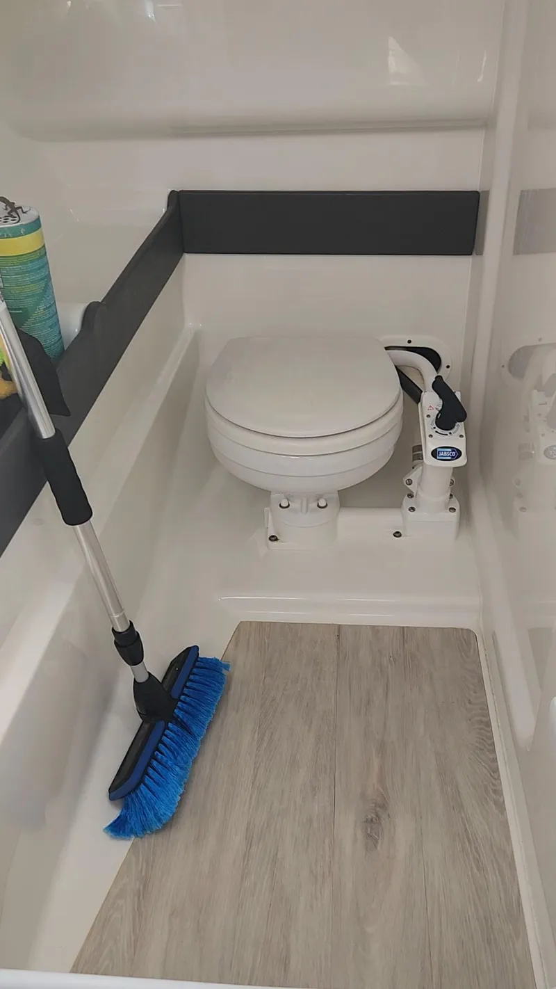 Slide: The Image of 2018 Formula 270 BR boat bathroom with toilet and cleaning supplies. - 18
