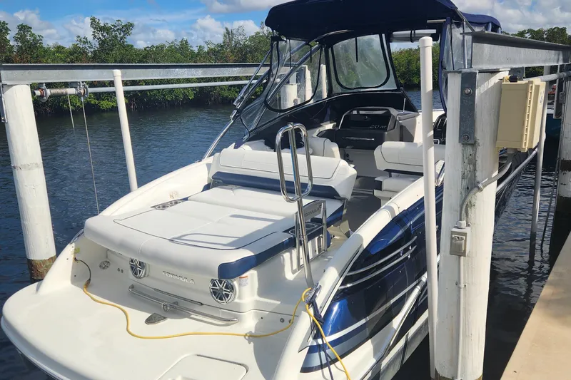 Slide: The Image of 2018 Formula 270 BR boat docked, featuring sleek design and spacious seating. - 2