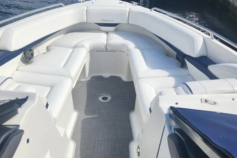 Slide: The Image of 2018 Formula 270 BR boat with spacious white seating and gray flooring. - 5
