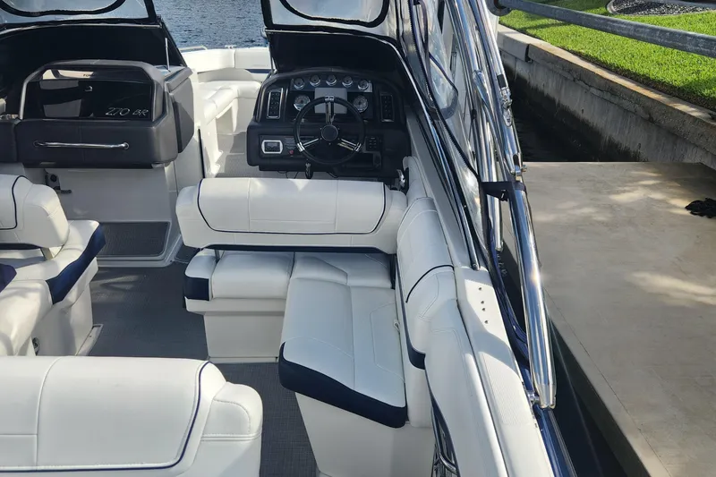 Slide: The Image of 2018 Formula 270 BR boat interior with white seating and dashboard. - 6
