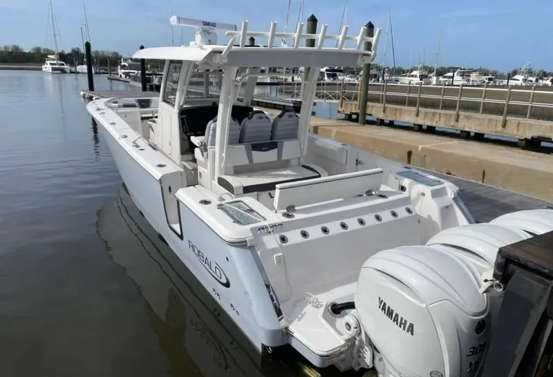 Slide: The Image of 2023 Robalo R360 Center Console boat docked with Yamaha engines. - 13