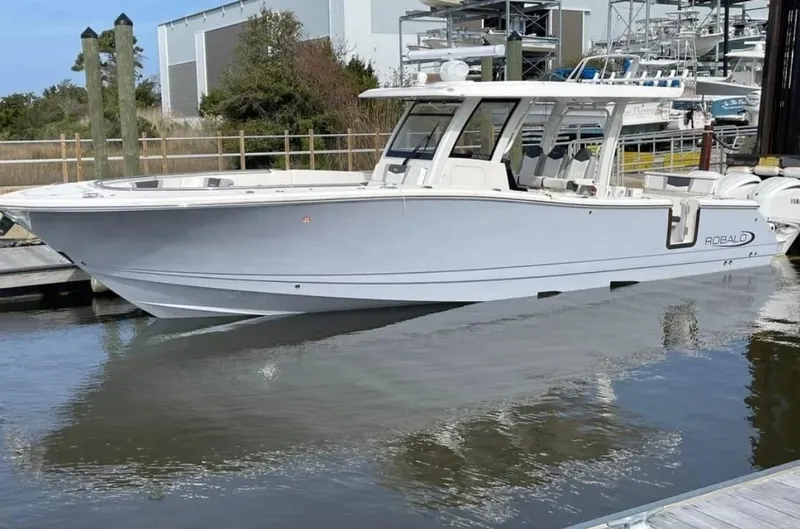Slide: The Image of 2023 Robalo R360 Center Console boat docked in marina. - 17