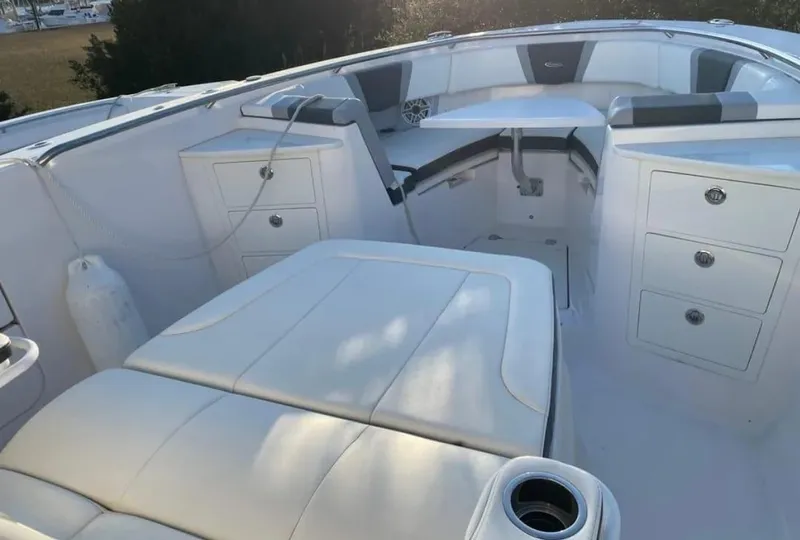 Slide: The Image of 2023 Robalo R360 Center Console boat interior with white seating and storage compartments. - 18