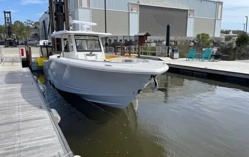 Slide: The Image of 2023 Robalo R360 Center Console boat docked at marina. - 3